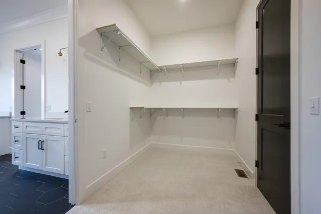 an empty room with a window and a ceiling fan