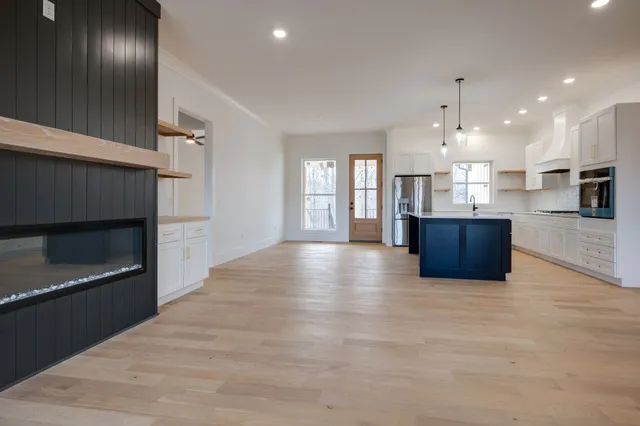 a view of a kitchen with a sink and a living room