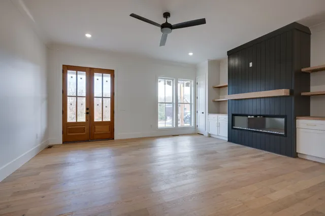 a view of an empty room and wooden floor