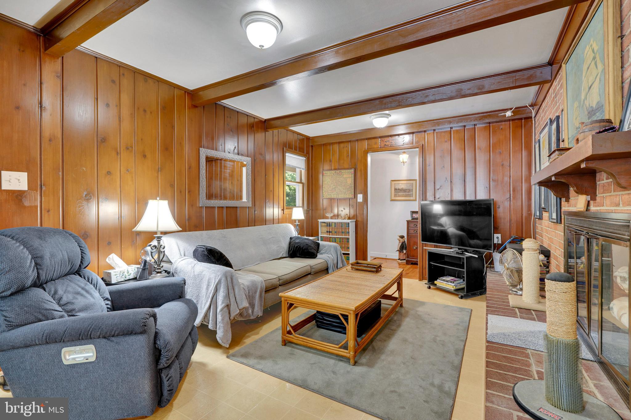 7614 Range Road Alexandria, VA 22306 - Photo 12 of 37 a living room with furniture a fireplace and a flat screen tv