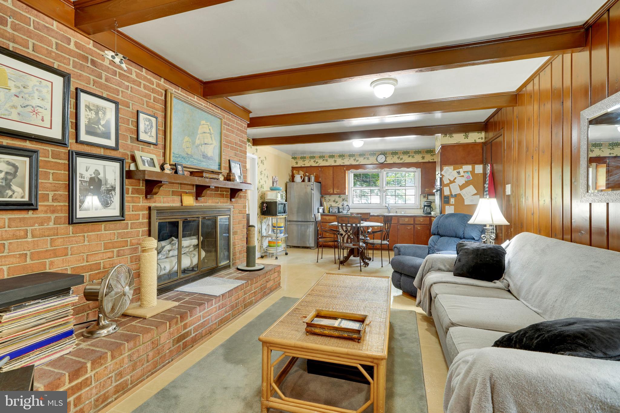 7614 Range Road Alexandria, VA 22306 - Photo 14 of 37 a living room with furniture a fireplace and a flat screen tv