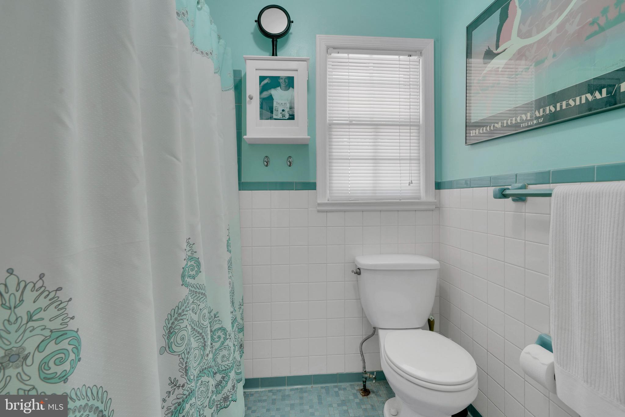 7614 Range Road Alexandria, VA 22306 - Photo 22 of 37 a bathroom with a toilet sink and mirror