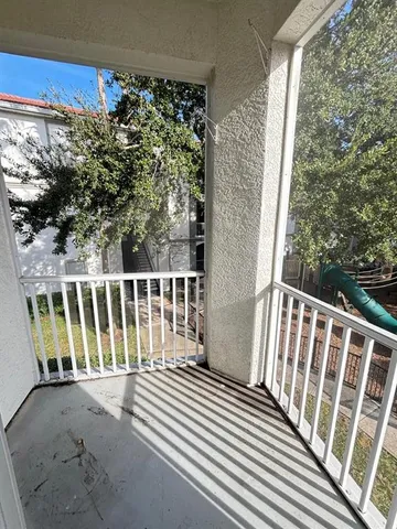 a view of a balcony with wooden floor