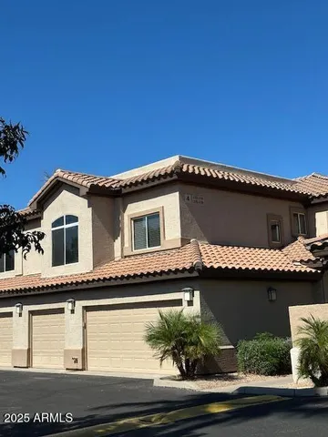 a front view of a house with plants