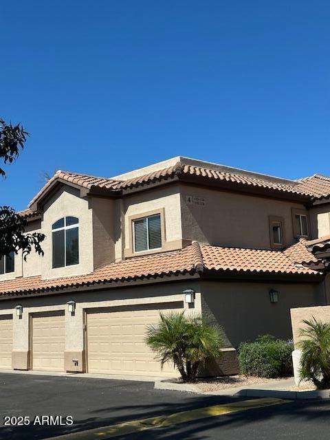 a front view of a house with plants