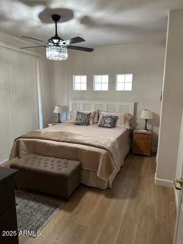 a bedroom with a bed and a chandelier