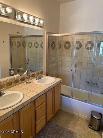 a bathroom with a tub sink and shower