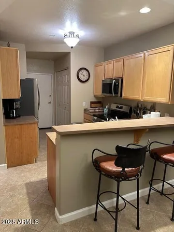 a kitchen with a table chairs sink and cabinets