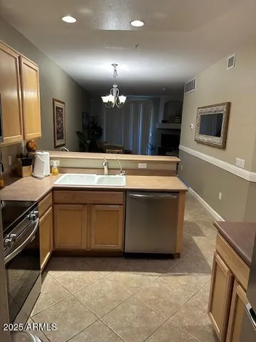 a view of a kitchen with a stove cabinets and a sink