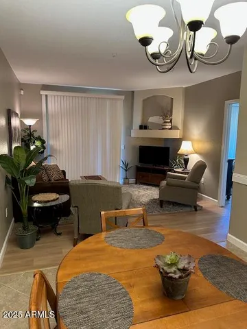 a living room with furniture chandelier and a rug