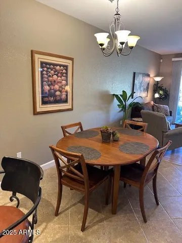 a view of a dining room with furniture and chandelier