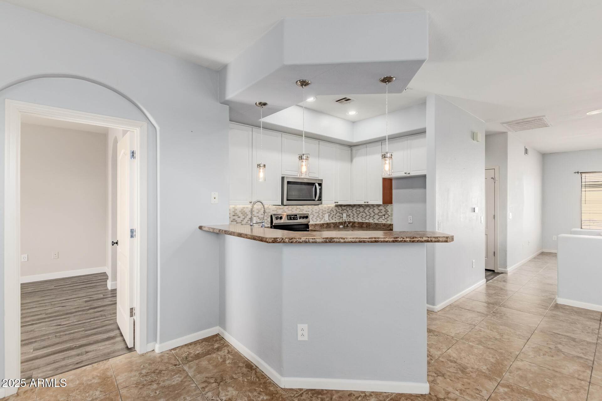 705 West Queen Creek Road, Unit 2146 Chandler, AZ 85248 - Photo 12 of 44 a kitchen with stainless steel appliances granite countertop a sink and a refrigerator
