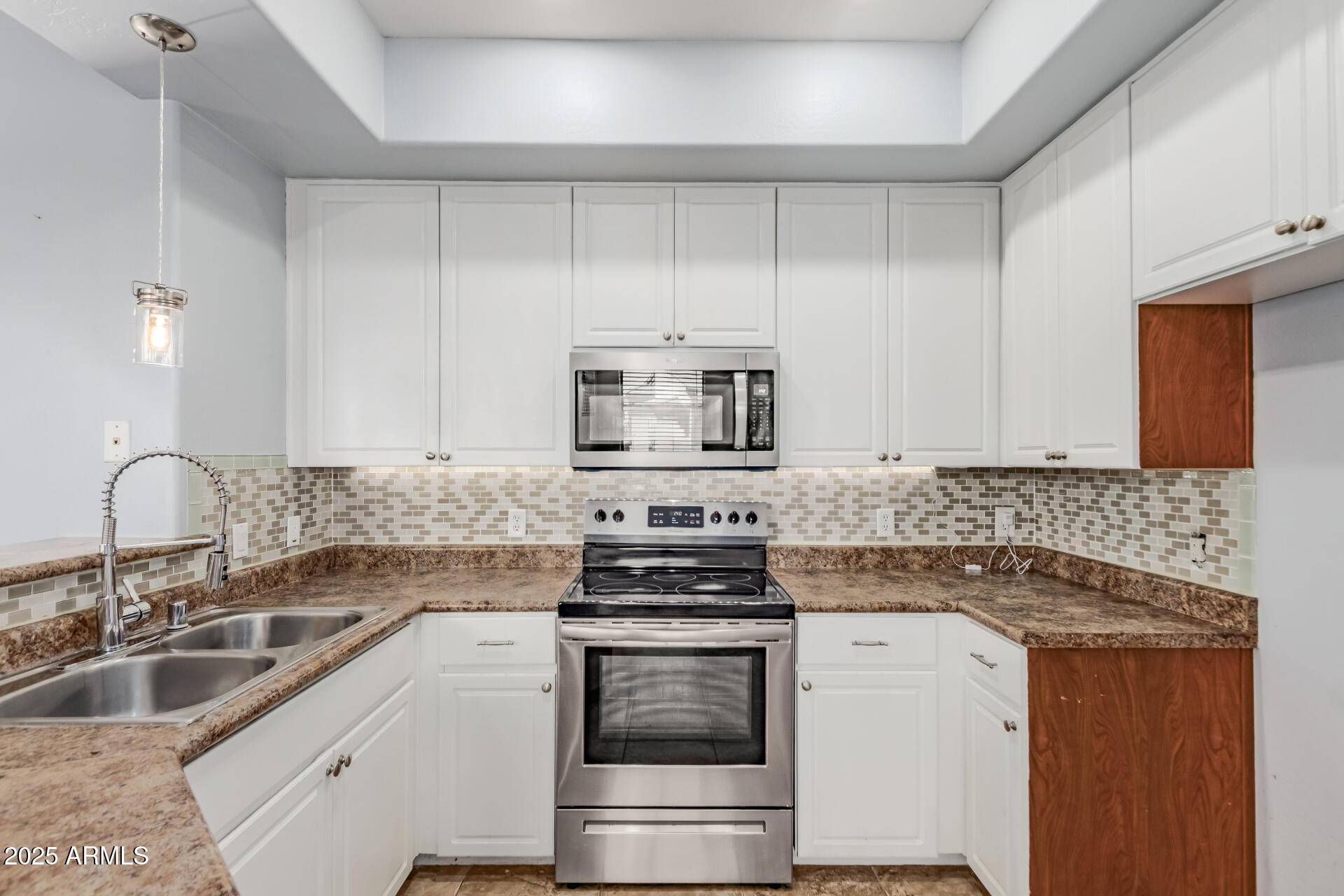 705 West Queen Creek Road, Unit 2146 Chandler, AZ 85248 - Photo 13 of 44 a kitchen with granite countertop a sink stove and cabinets