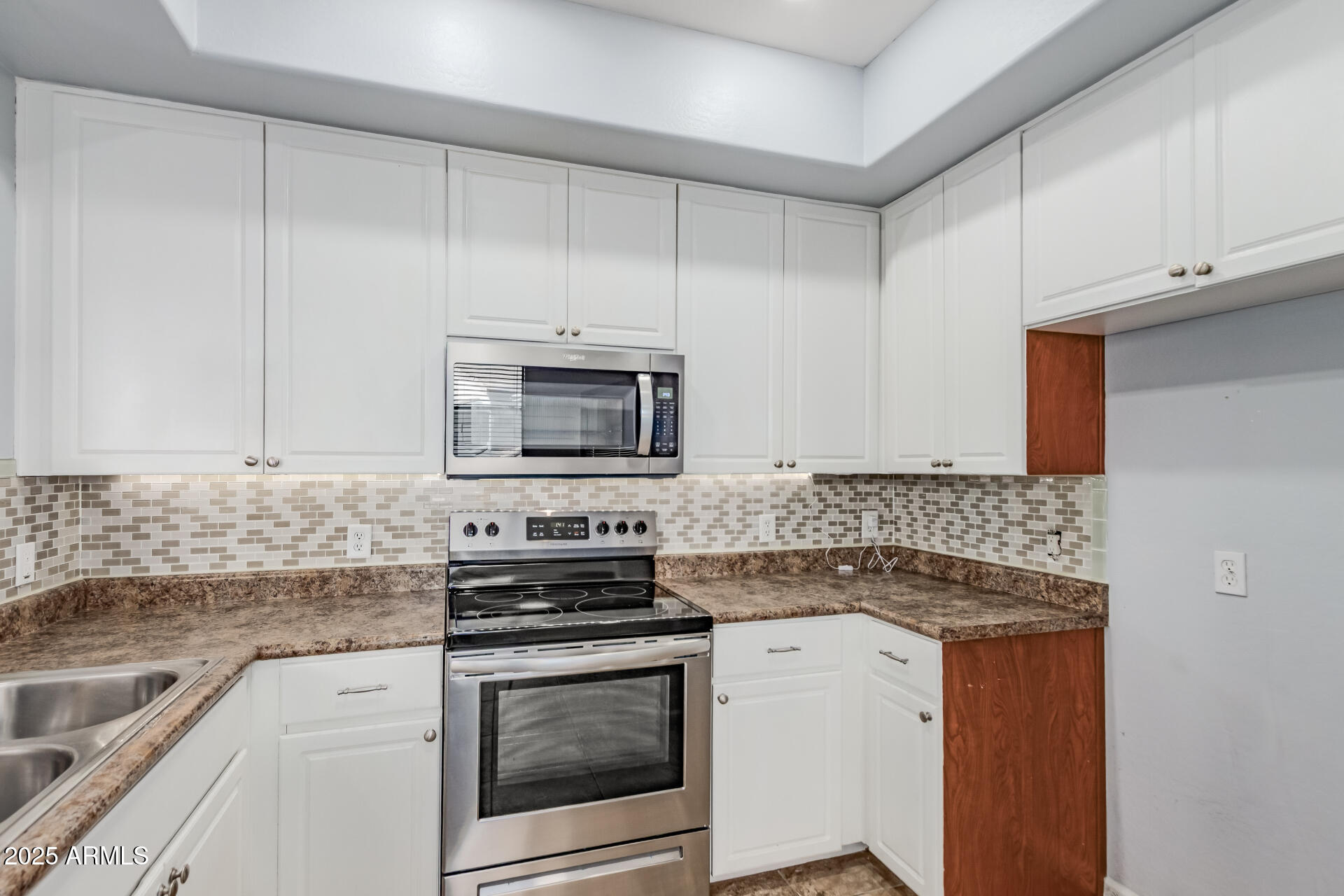 705 West Queen Creek Road, Unit 2146 Chandler, AZ 85248 - Photo 14 of 44 a kitchen with stainless steel appliances granite countertop a stove microwave and sink