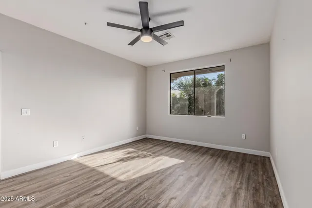 wooden floor in an empty room with a window