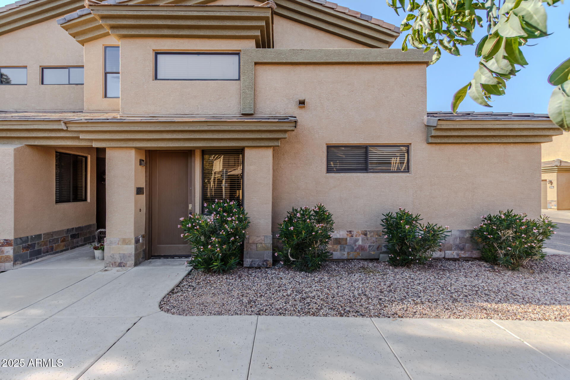 705 West Queen Creek Road, Unit 2146 Chandler, AZ 85248 - Photo 2 of 44 a view of a house with potted plants