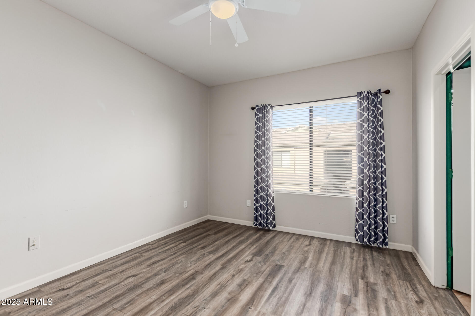 705 West Queen Creek Road, Unit 2146 Chandler, AZ 85248 - Photo 22 of 44 an empty room with wooden floor and windows