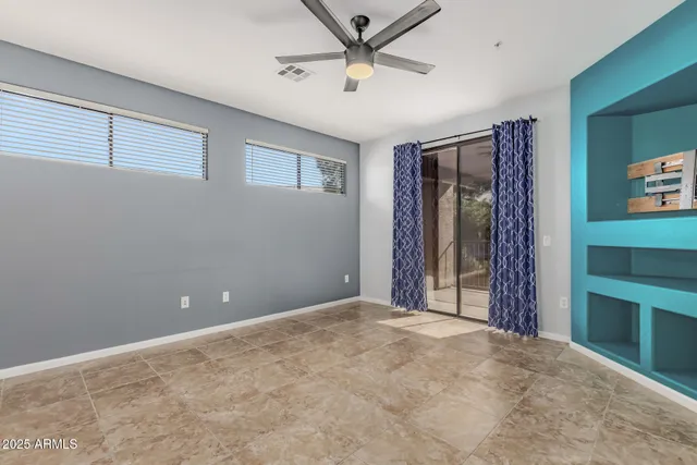 a view of a livingroom with a ceiling fan and window