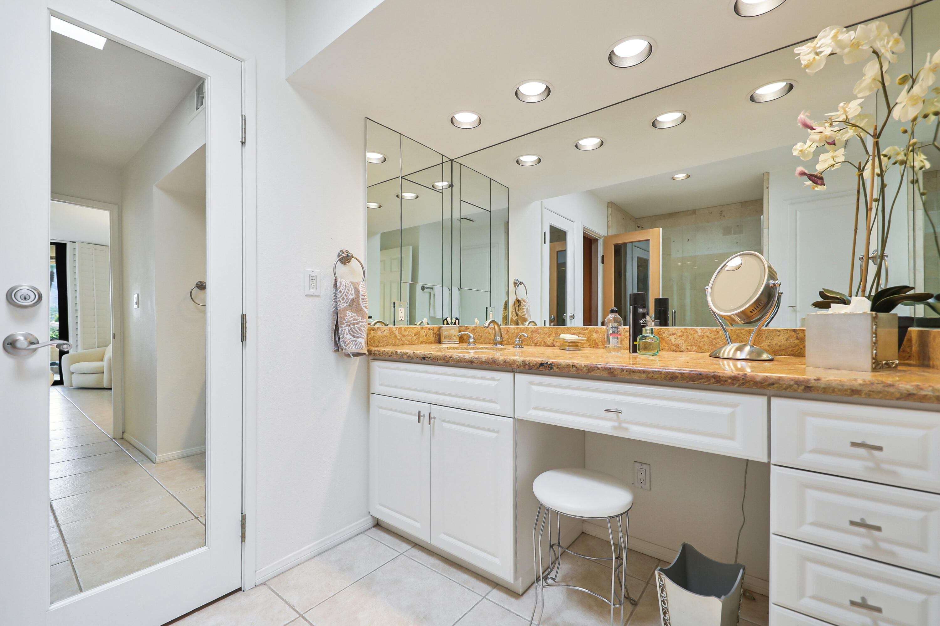 27 Seville Drive Rancho Mirage, CA 92270 - Photo 13 of 50 a bathroom with a granite countertop sink a toilet and a mirror