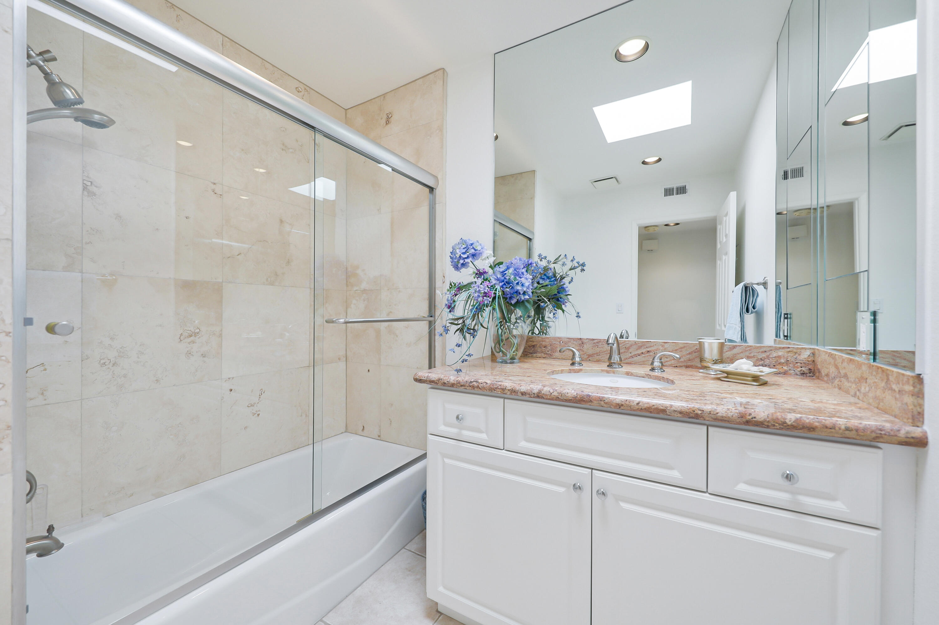 27 Seville Drive Rancho Mirage, CA 92270 - Photo 18 of 50 a bathroom with a granite countertop sink mirror and a bathtub