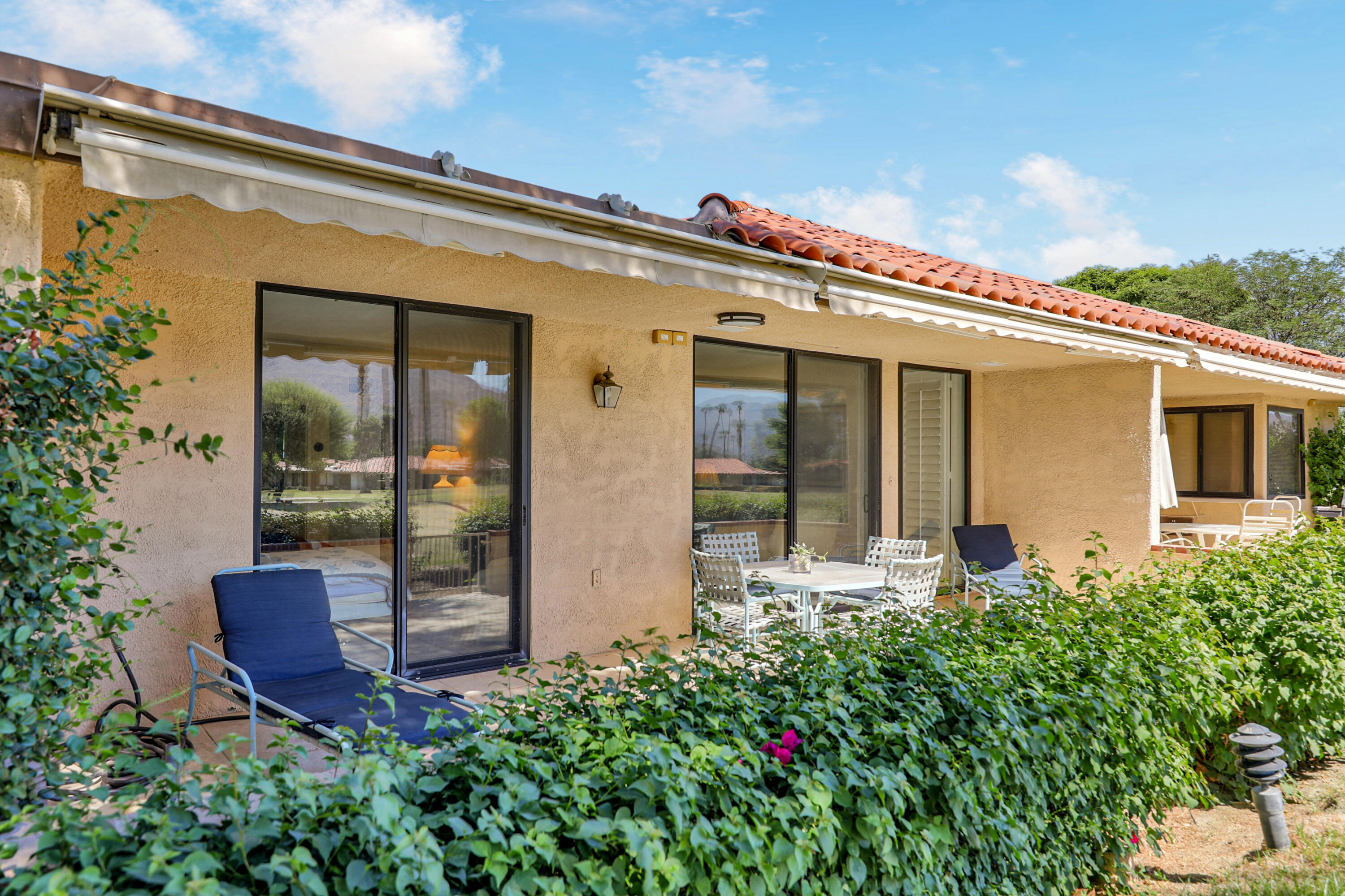 27 Seville Drive Rancho Mirage, CA 92270 - Photo 24 of 50 a front view of a house with garden