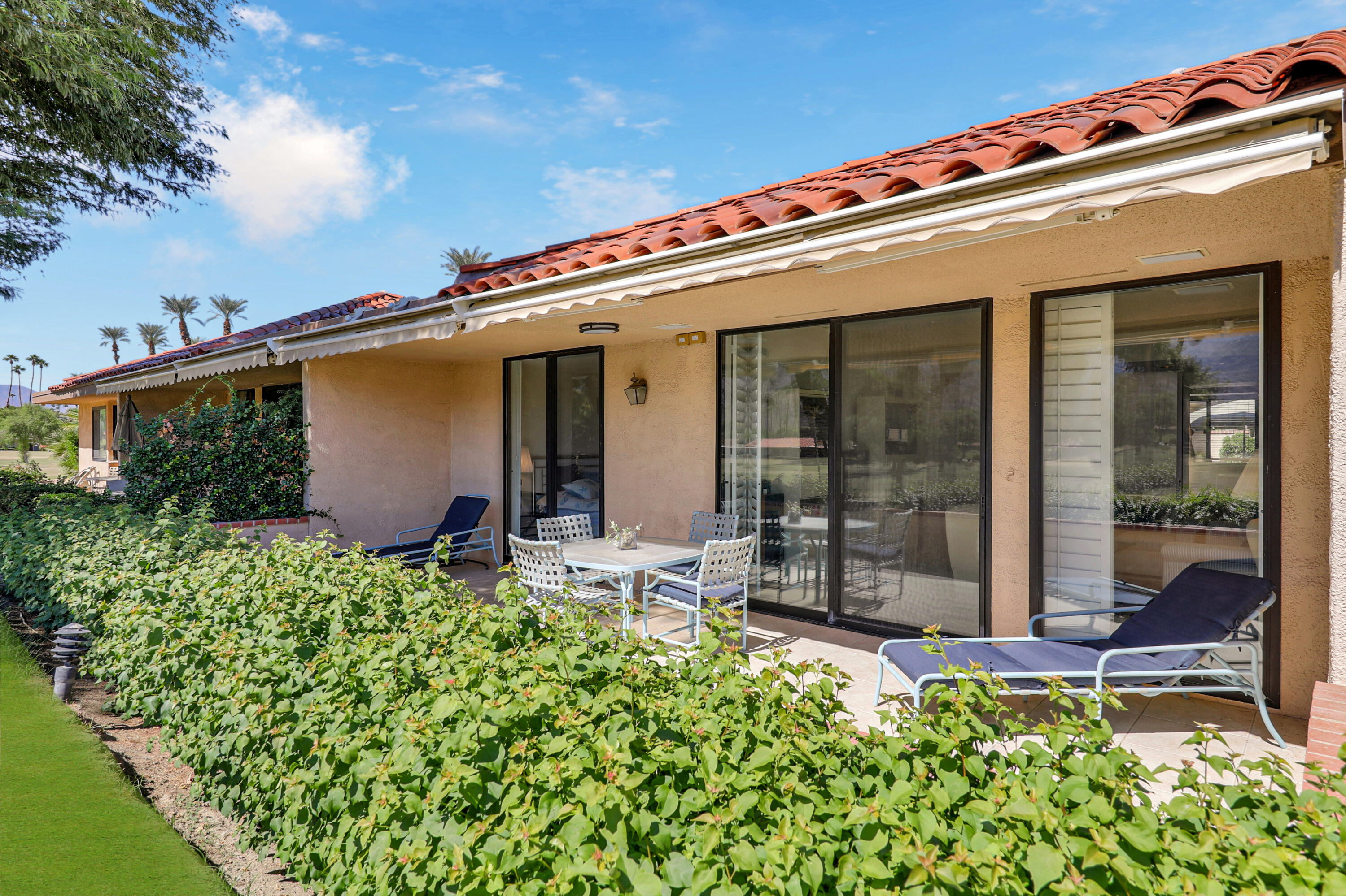 27 Seville Drive Rancho Mirage, CA 92270 - Photo 25 of 50 front view of a house with a small yard
