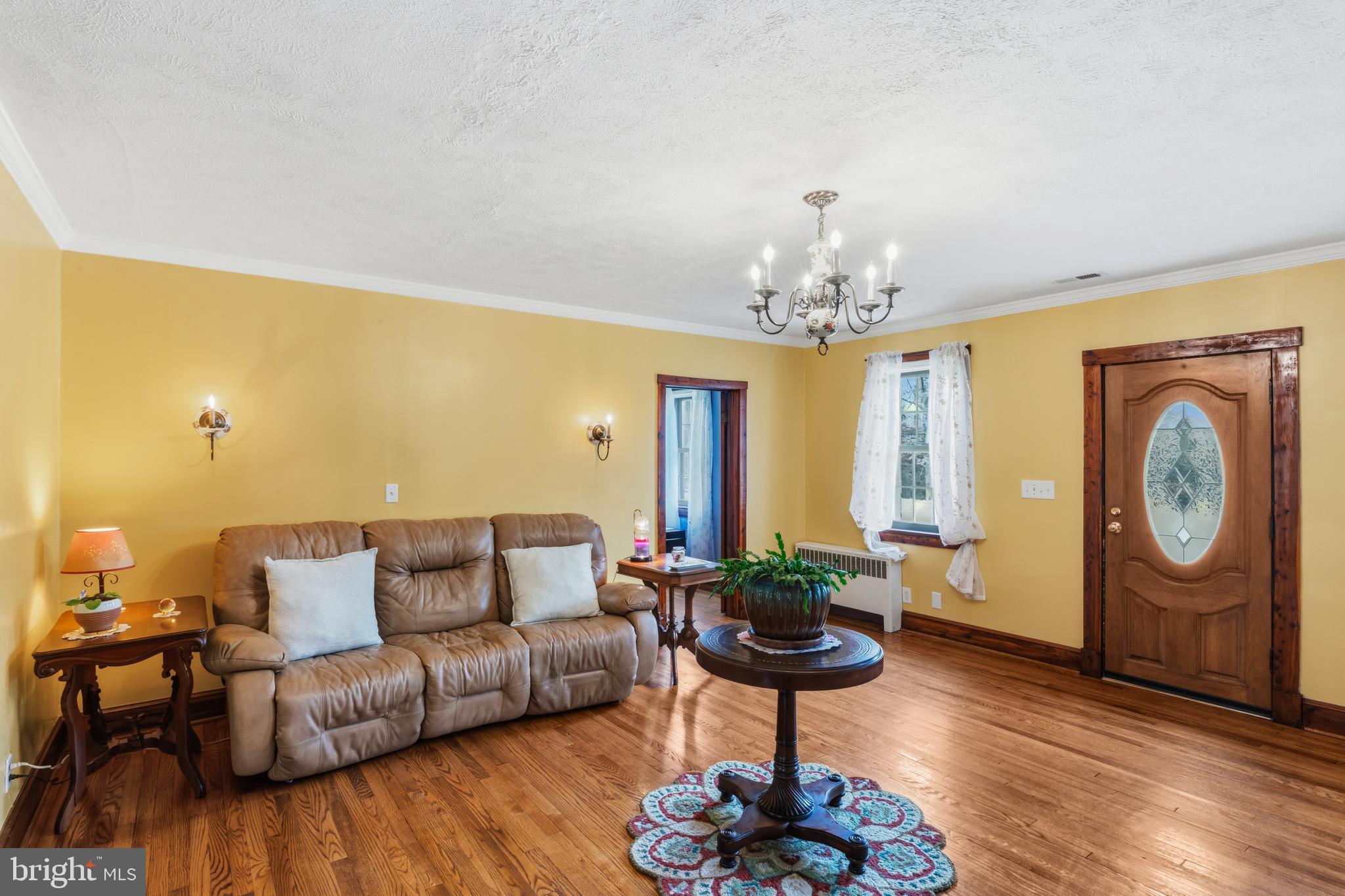 3593 Strasburg Road Strasburg, VA 22657 - Photo 10 of 113 a living room with furniture and a chandelier