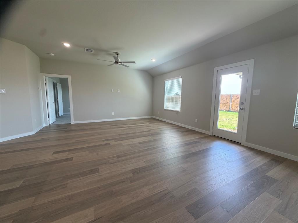 517 River Rdg Drive McKinney, TX 75071 - Photo 5 of 14 an empty room with wooden floor and windows