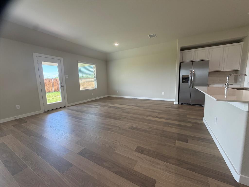 517 River Rdg Drive McKinney, TX 75071 - Photo 6 of 14 an empty room with wooden floor and windows