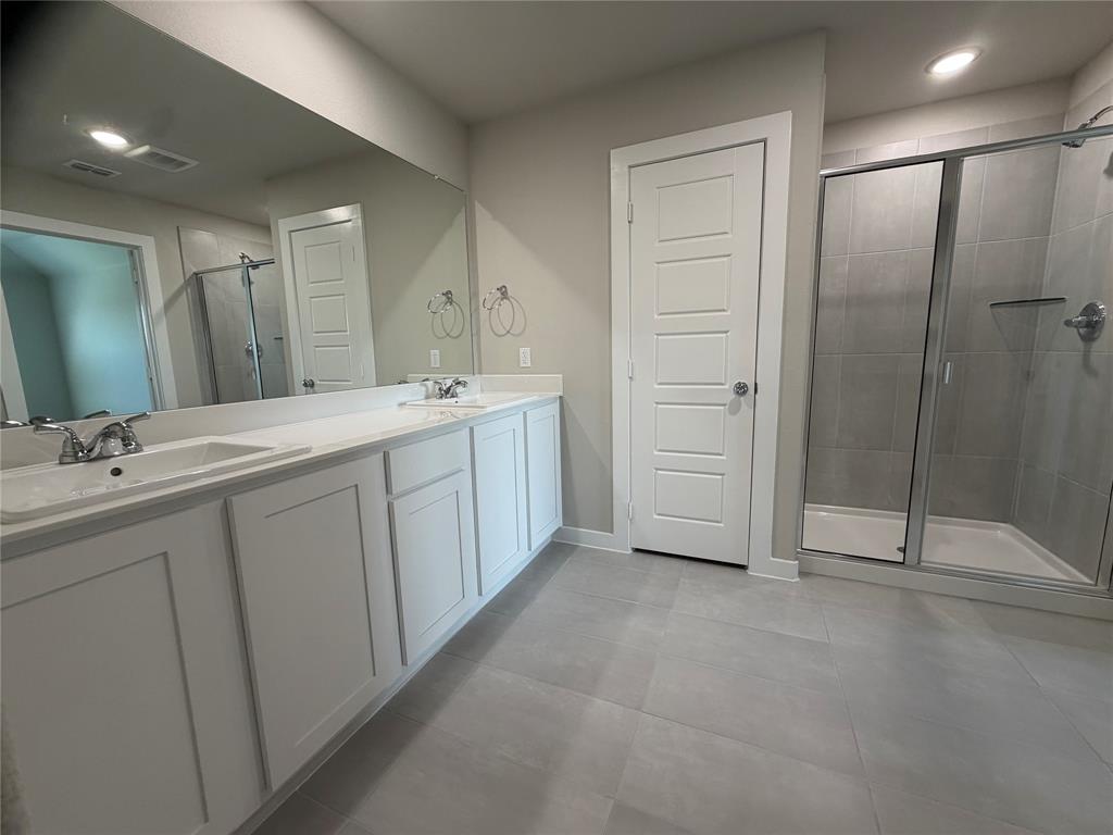 517 River Rdg Drive McKinney, TX 75071 - Photo 8 of 14 a spacious bathroom with a shower sink and mirror