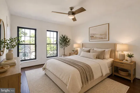 a bedroom with a bed and a potted plant