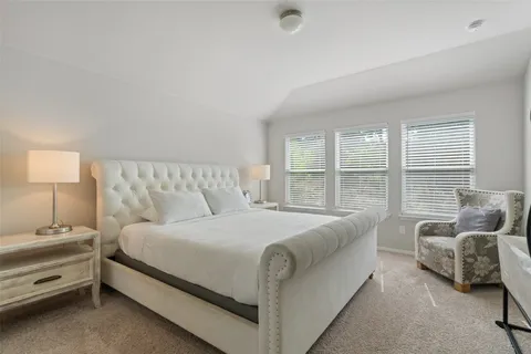 a bedroom with bed and furniture with large window