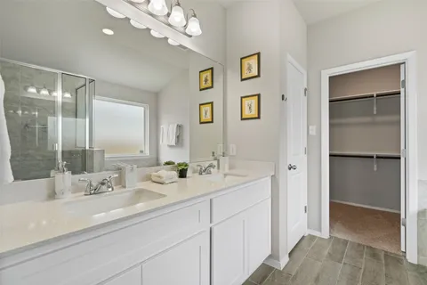 a bathroom with a sink double vanity and a mirror