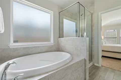 a bathroom with a tub and shower