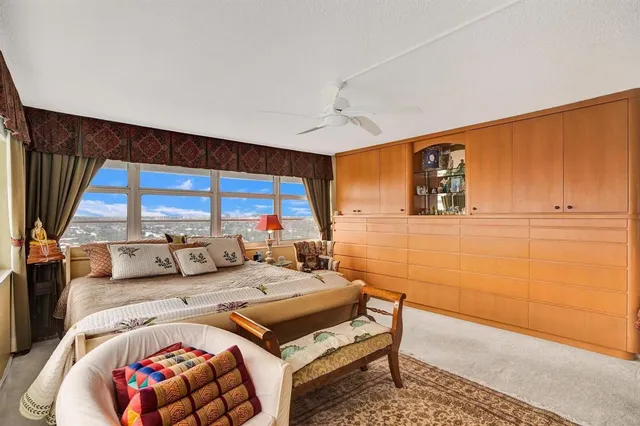 a bedroom with furniture and a large window