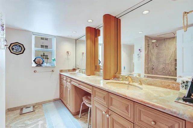 a bathroom with a double vanity sink and a mirror