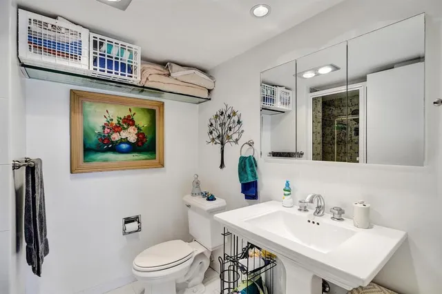 a bathroom with a sink a mirror and a toilet