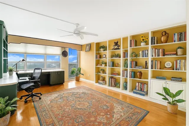 a reading room with furniture rug and a large window
