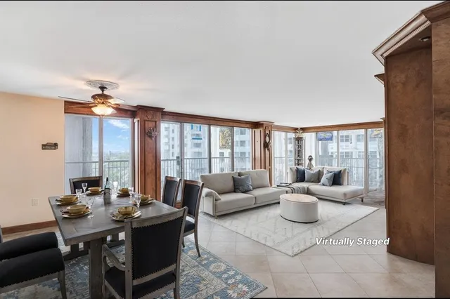 a living room with furniture and large windows