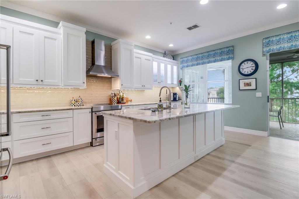 3530 Lansing Loop, Unit 204 Estero, FL 33928 - Photo 12 of 48 a kitchen with a sink stove and cabinets