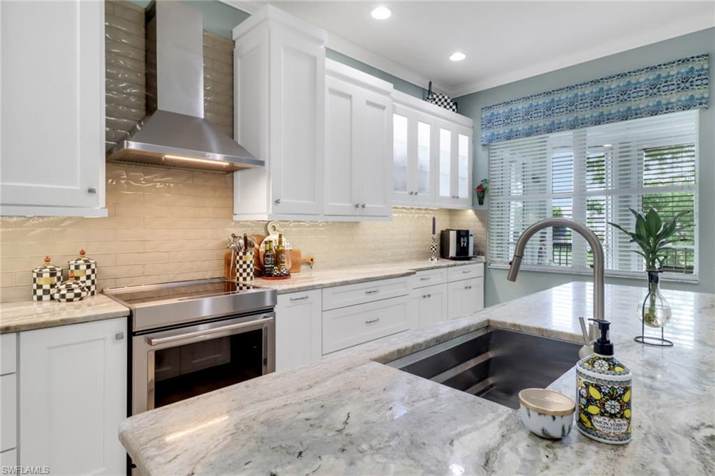 3530 Lansing Loop, Unit 204 Estero, FL 33928 - Photo 13 of 48 a kitchen with a sink appliances and cabinets