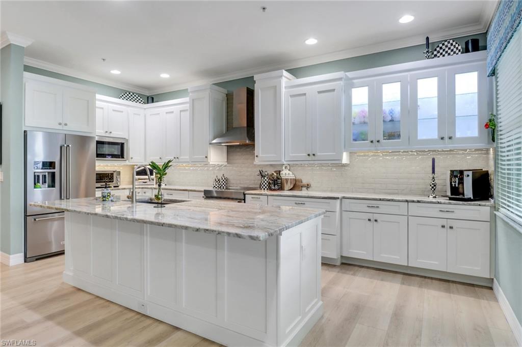 3530 Lansing Loop, Unit 204 Estero, FL 33928 - Photo 14 of 48 a kitchen with stainless steel appliances granite countertop a stove a sink and a refrigerator