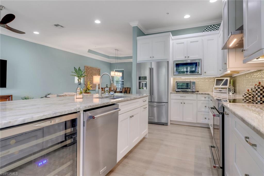 3530 Lansing Loop, Unit 204 Estero, FL 33928 - Photo 15 of 48 a kitchen with white cabinets and sink