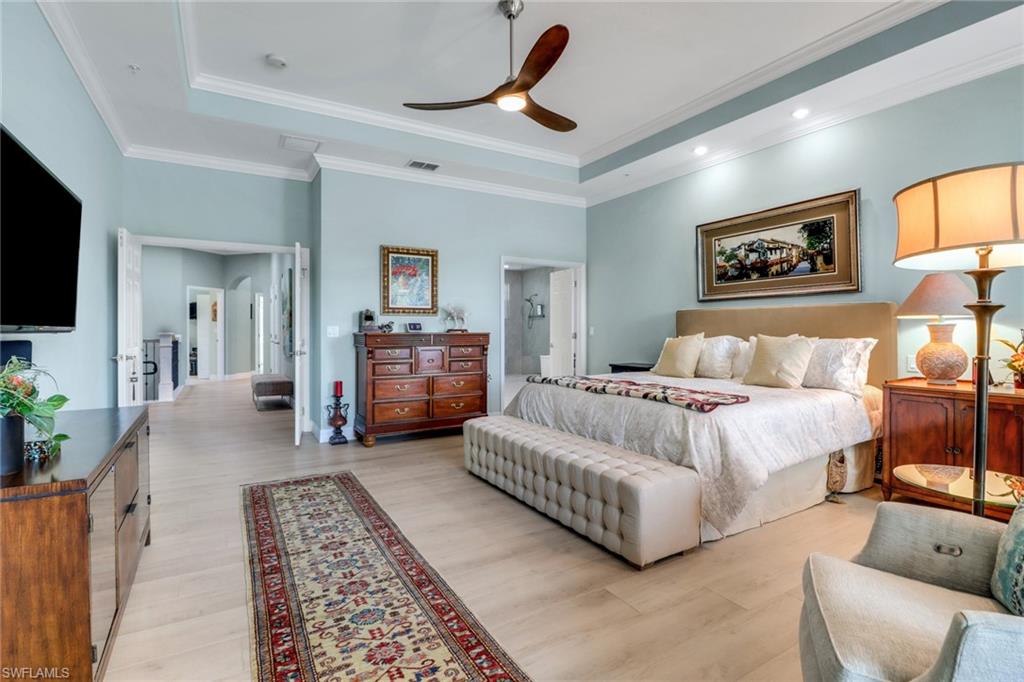 3530 Lansing Loop, Unit 204 Estero, FL 33928 - Photo 18 of 48 a spacious bedroom with a bed a couch and a flat screen tv