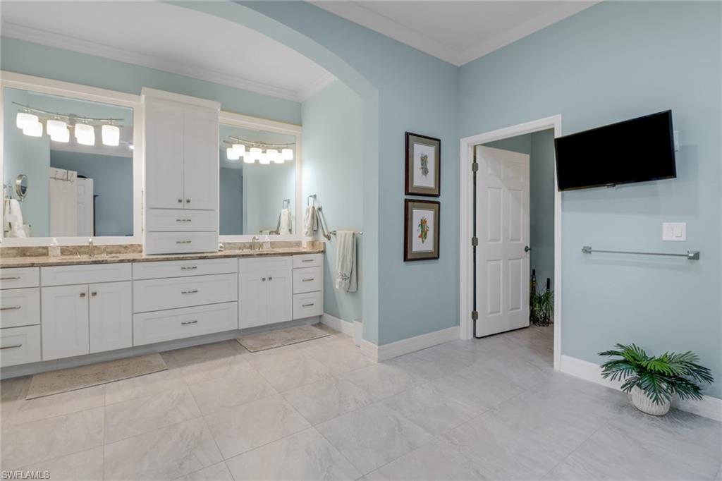 3530 Lansing Loop, Unit 204 Estero, FL 33928 - Photo 20 of 48 a spacious bathroom with a granite countertop sink a mirror and shower