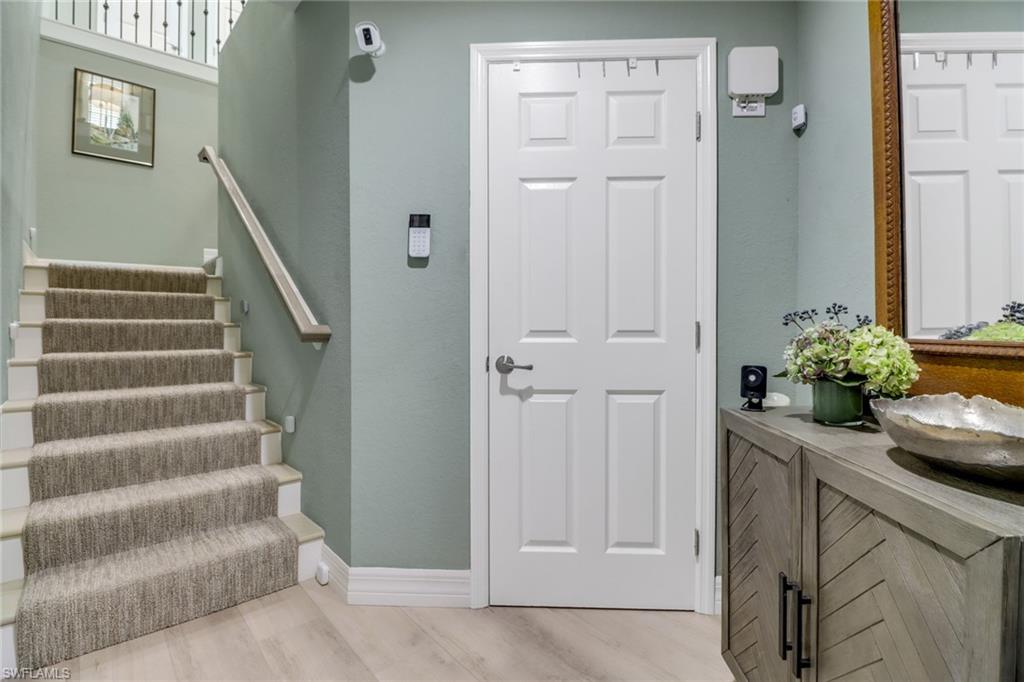 3530 Lansing Loop, Unit 204 Estero, FL 33928 - Photo 2 of 48 a view of entryway with wooden floor and stairs