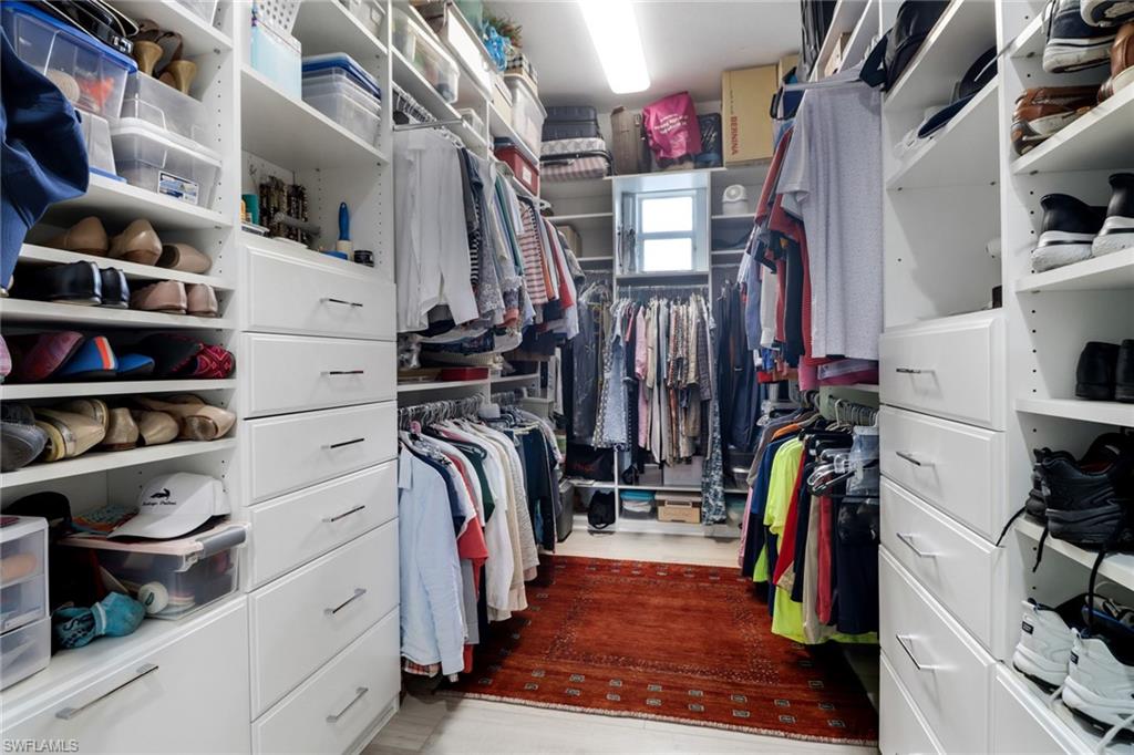 3530 Lansing Loop, Unit 204 Estero, FL 33928 - Photo 23 of 48 a view of walk in closet with clothes and shoes