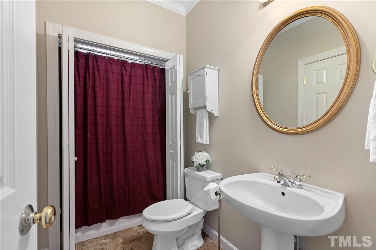 106 Ecklin Lane Cary, NC 27519 - Photo 13 of 29 a bathroom with a sink a toilet and a mirror