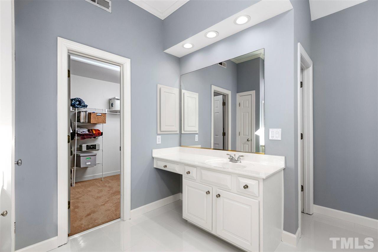 106 Ecklin Lane Cary, NC 27519 - Photo 17 of 29 a bathroom with a sink a mirror and a shower