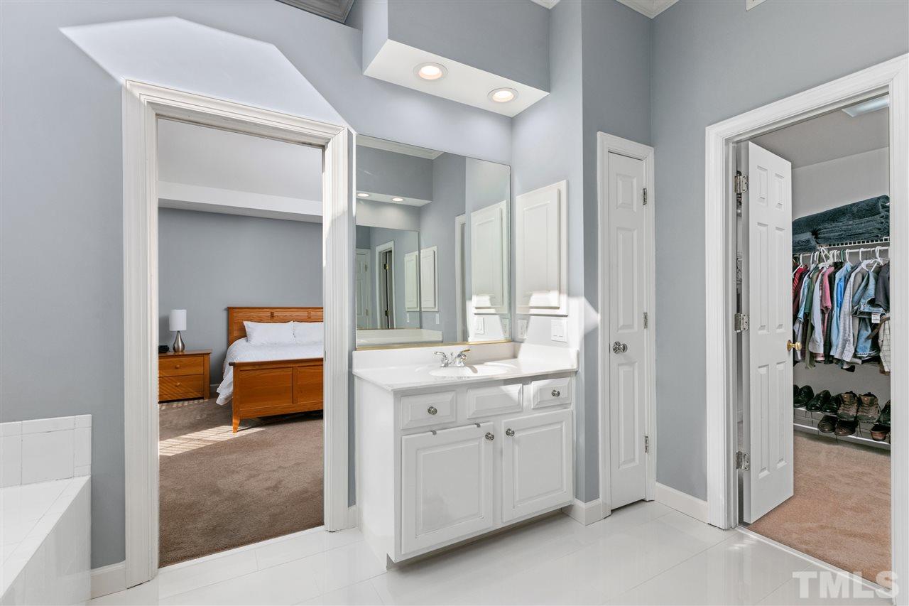 106 Ecklin Lane Cary, NC 27519 - Photo 18 of 29 a en suite bathroom with a sink and a mirror